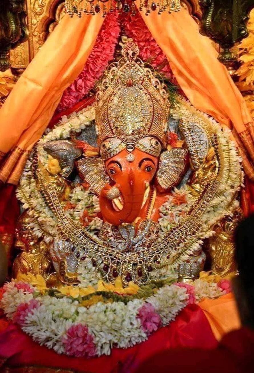 Ornate Lord Ganesha Murti Adorned With Jewels And Flower Garlands HD phone wallpaper