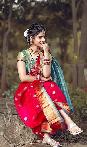 Elegant Woman in Traditional Marathi Saree with Gold Jewelry and Floral Hairpiece HD phone wallpaper