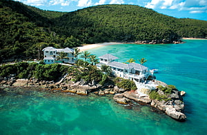 Luxury Tropical Villa on Rocky Shoreline with Turquoise Water and Lush Green Hills HD wallpaper