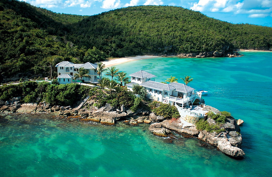 Luxury Tropical Villa on Rocky Shoreline with Turquoise Water and Lush Green Hills HD wallpaper