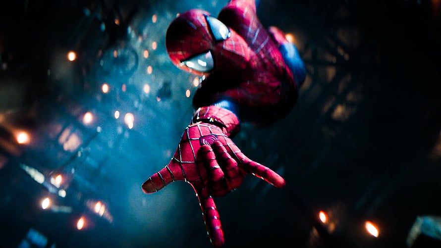 Spider-Man Reaching Down in Dark Industrial Setting with Glowing Embers HD wallpaper