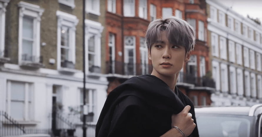 Jaehyun from NCT in a black jacket with silver hair on a London street HD wallpaper