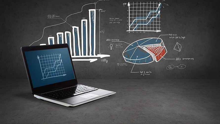 Laptop with data charts and graphs on a dark chalkboard background HD wallpaper