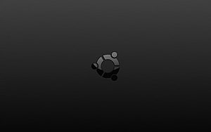 Minimalist Ubuntu Logo on Dark Textured Background HD wallpaper