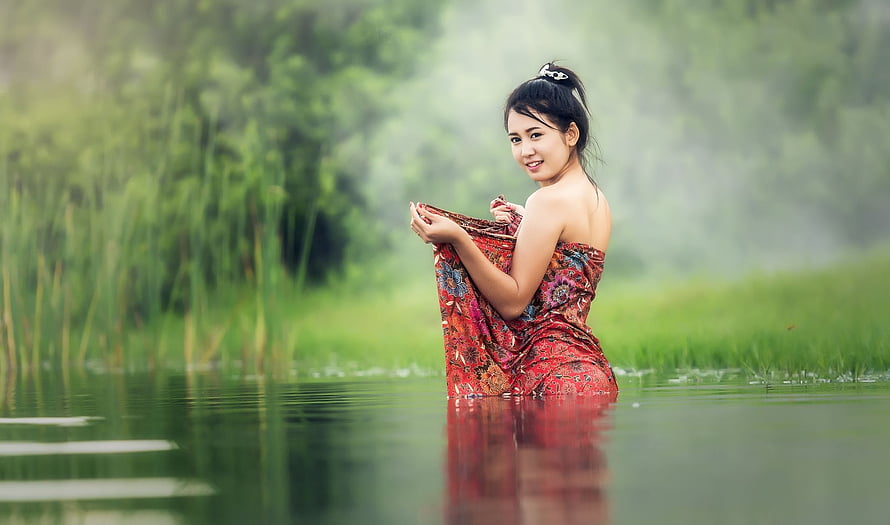 Asian Woman in Red Patterned Dress Standing in Misty River Water HD wallpaper