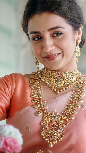 Trisha in Traditional Saree with Ornate Gold Jewelry and Floral Accents HD phone wallpaper