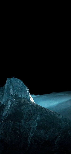 Dark Mountain Peak Silhouette Against Black Sky with Cool Blue Tint HD phone wallpaper