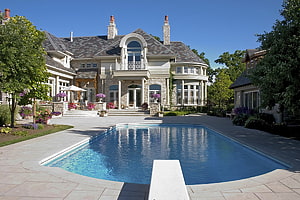 Luxurious Stone Manor With Expansive Swimming Pool And Manicured Garden HD wallpaper