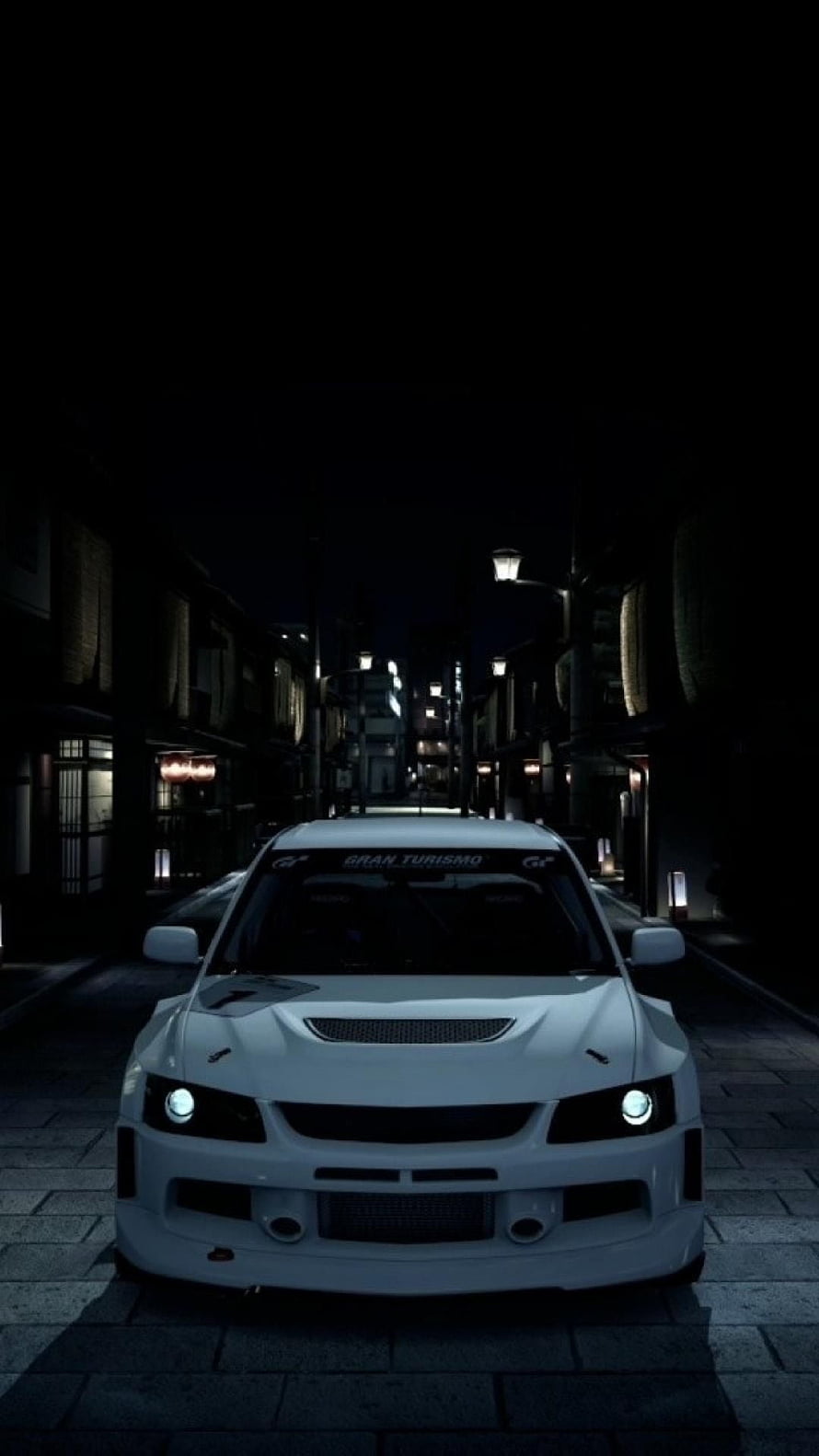White Mitsubishi Lancer Evolution V parked on a dark Japanese street at night with headlights on HD phone wallpaper