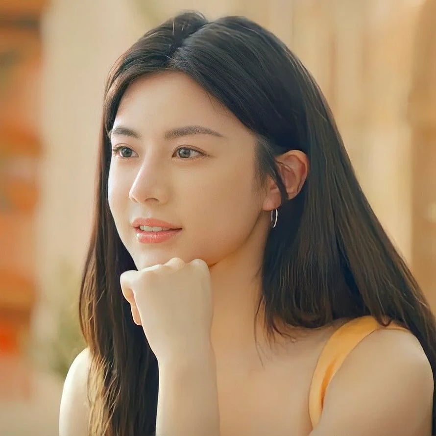Go Yoon Jung Portrait: Soft-Lit Close-Up of a Young Woman in a Yellow Top HD phone wallpaper