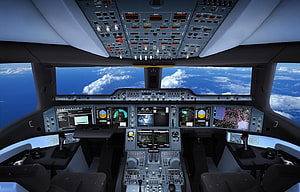 Airbus A350 Cockpit Interior View with Digital Displays and Clouds Outside HD wallpaper