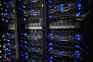 Illuminated Data Center Server Racks with Blue LED Lighting and Dense Cabling HD wallpaper