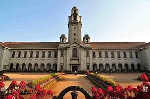 Indian Institute of Science Bangalore Main Building with Central Tower and Flower Gardens HD wallpaper