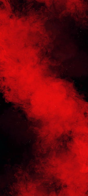 Vibrant red cosmic nebula swirling through deep black space with scattered starlight HD phone wallpaper