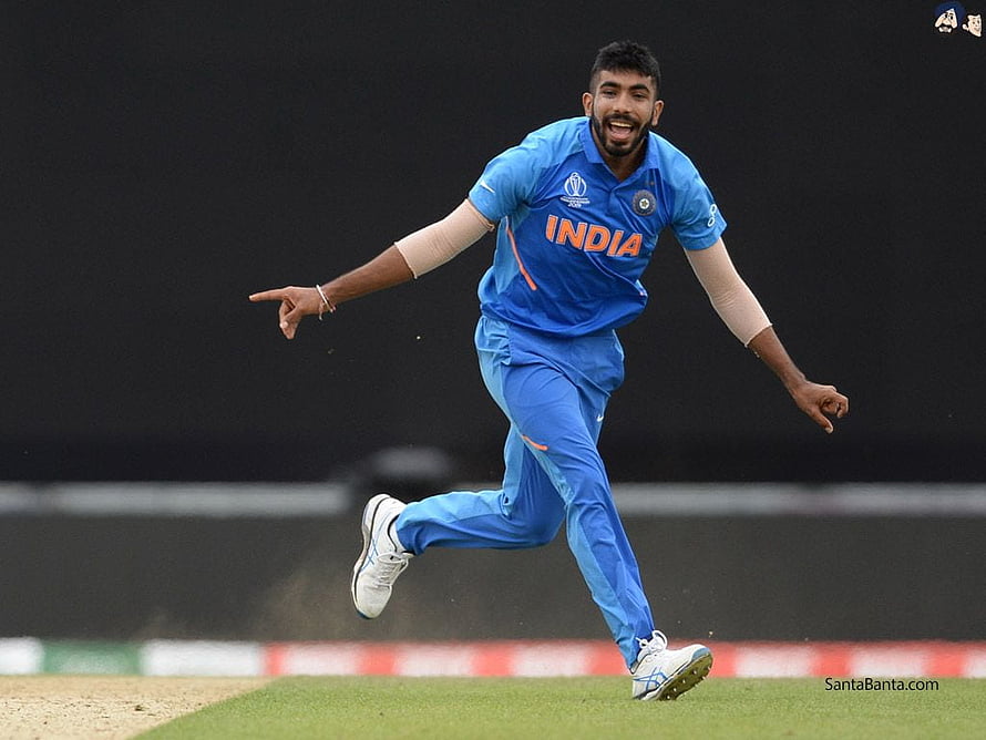 Jasprit Bumrah in India Blue Kit Celebrating on the Cricket Field HD wallpaper