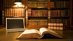 Vintage Law Library with Antique Books and Modern Laptop on Wooden Desk HD wallpaper