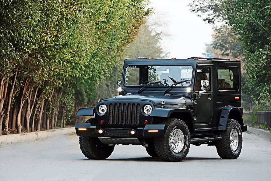 Black Mahindra Thar SUV Driving on a Tree-Lined Road HD wallpaper