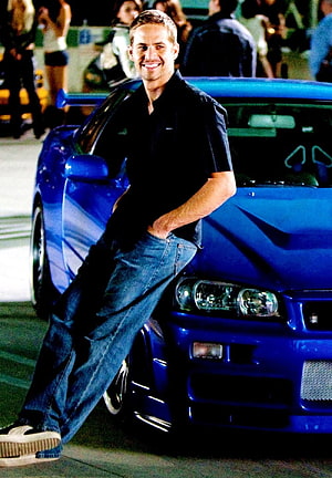 Paul Walker Leaning Against Blue Nissan Skyline in Fast and Furious HD phone wallpaper