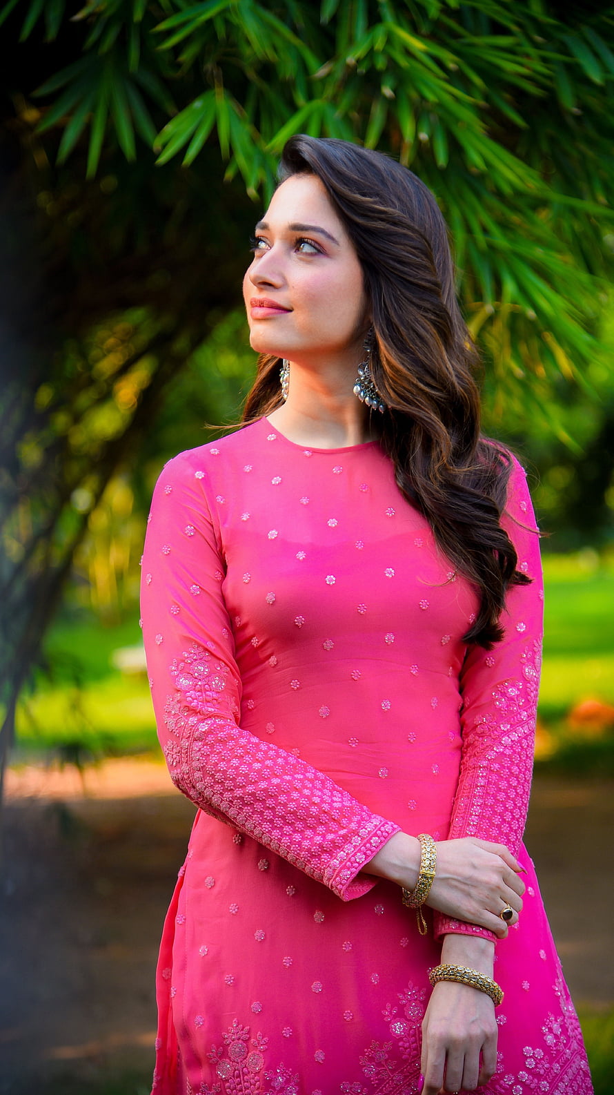 Tamanna Bhatia in a vibrant pink embroidered kurta with gold jewelry in a lush garden HD phone wallpaper