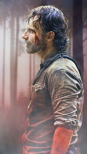 Rick Grimes from The Walking Dead in a gritty forest profile with blood on his face HD phone wallpaper