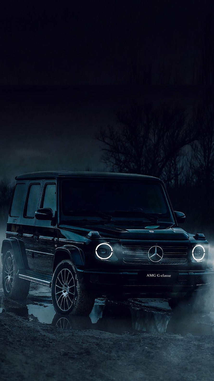 Black Mercedes-Benz G-Class AMG SUV with glowing headlights in a dark misty night scene HD phone wallpaper