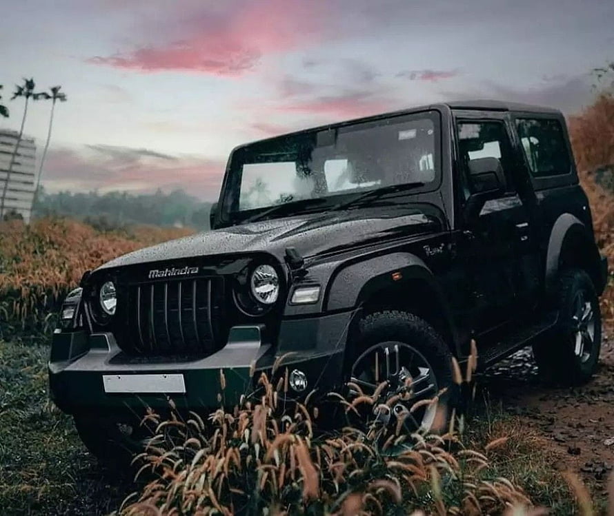 Black Mahindra Thar SUV parked on a dirt trail at dusk with dramatic pink clouds HD wallpaper