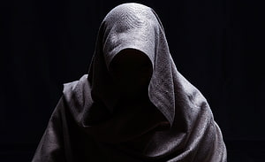 Mysterious hooded figure in shadow with dramatic low-key lighting HD wallpaper
