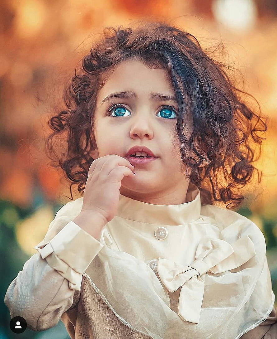 Anahita Hashemzadeh Portrait: Curly-Haired Toddler with Blue Eyes in Vintage Blouse HD phone wallpaper
