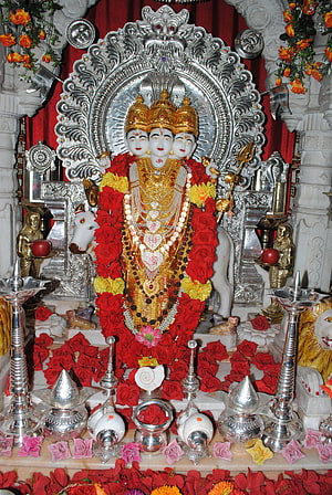 Dattatreya Murti Adorned With Red Rose Garlands And Silver Temple Decorations HD phone wallpaper