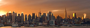 New York City Skyline at Golden Hour with Dramatic Sunset and Waterfront View HD wallpaper
