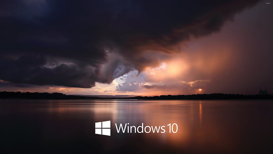Windows 10 Default Wallpaper Featuring Dramatic Storm Clouds Over a Calm Lake at Sunset HD wallpaper