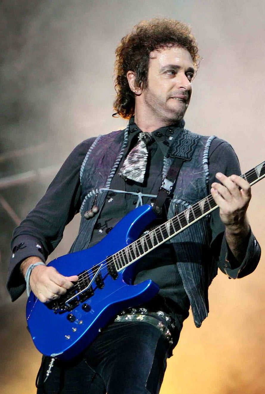 Gustavo Cerati performing live with a blue electric guitar on stage HD phone wallpaper