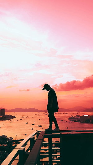 Silhouette of a man standing on a rooftop overlooking a harbor at sunset, Single Boy Attitude, Sad, Alone HD phone wallpaper