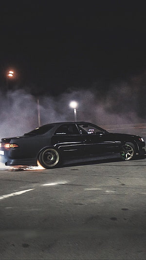 Black Toyota Mark 2 JZX90 Drifting at Night with Tire Smoke in Parking Lot HD phone wallpaper
