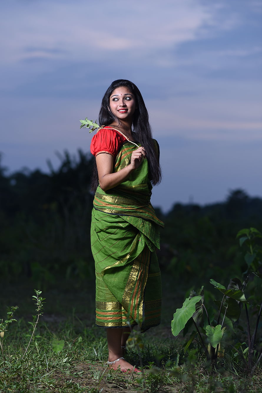 Joy Deb in a Green Silk Saree with Red Blouse Standing in a Rural Field at Dusk HD phone wallpaper