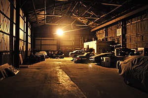 Moody Vintage Car Garage Interior With Warm Industrial Lighting HD wallpaper