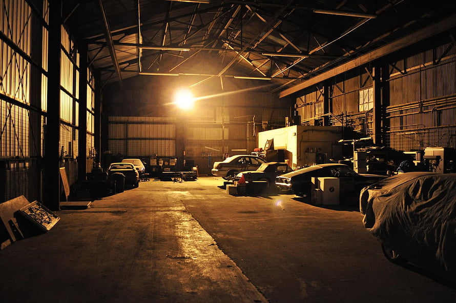 Moody Vintage Car Garage Interior With Warm Industrial Lighting HD wallpaper