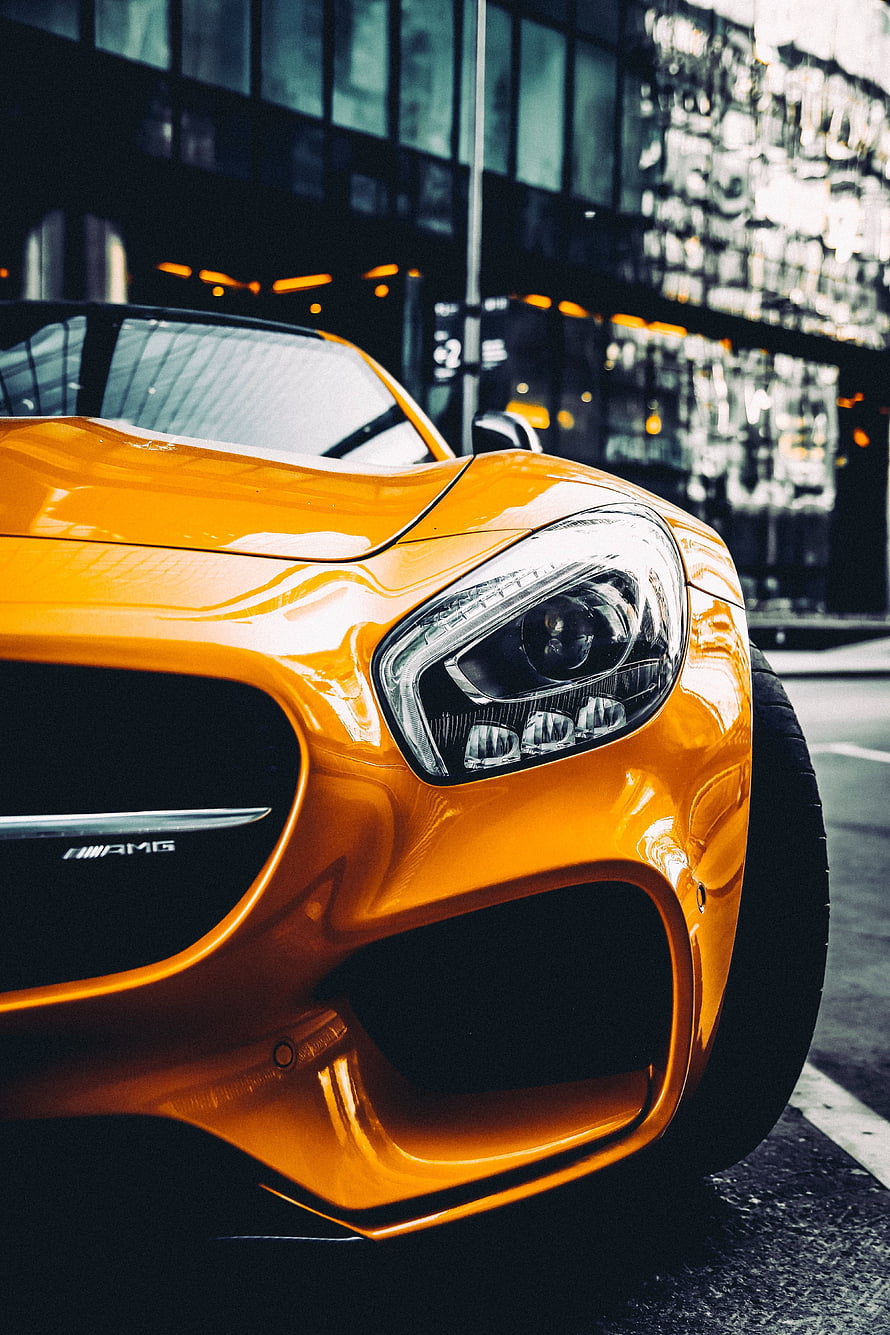 Orange Mercedes AMG GT Front Headlight Close-Up in Urban Setting HD phone wallpaper
