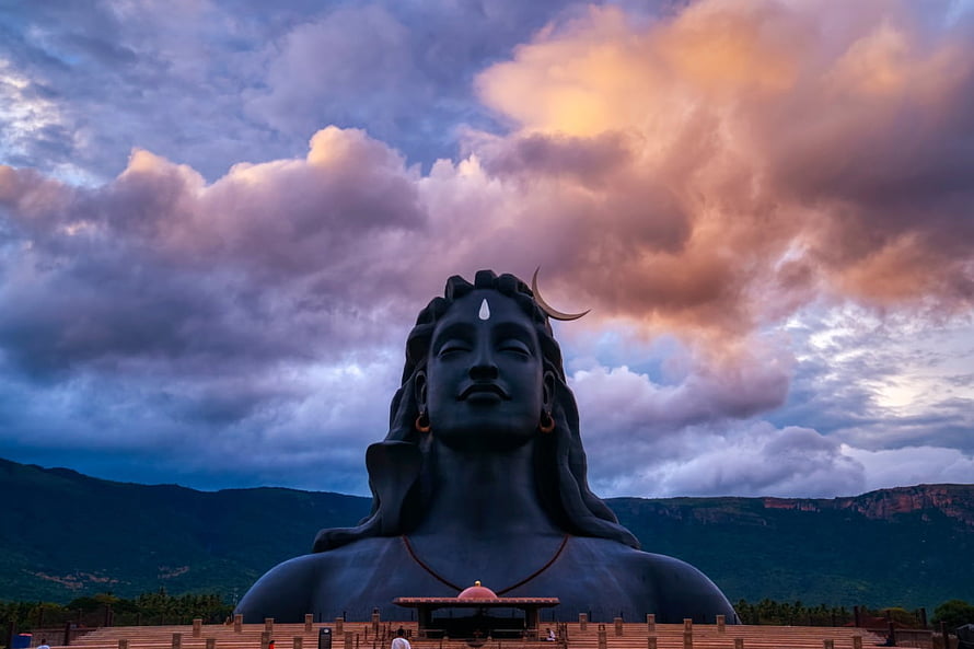 Adiyogi Statue at Isha Foundation with Dramatic Sunset Sky and Mountain Backdrop HD wallpaper
