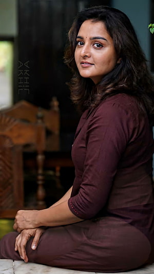 Manju Warrier in a Maroon Kurta Sitting Indoors HD phone wallpaper