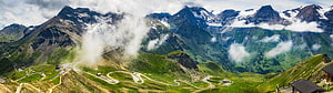 Panoramic Alpine Mountain Landscape with Winding Switchback Road and Snow-Capped Peaks HD wallpaper