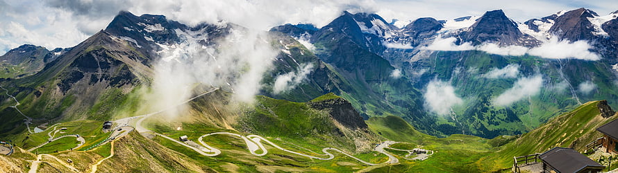 Panoramic Alpine Mountain Landscape with Winding Switchback Road and Snow-Capped Peaks HD wallpaper