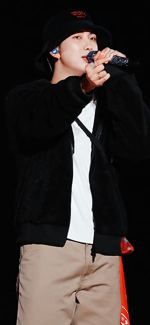 RM from BTS performing live on stage in a black bucket hat and jacket HD phone wallpaper