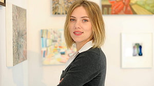 Scarlett Johansson in a gallery setting wearing a dark blazer and white shirt HD wallpaper