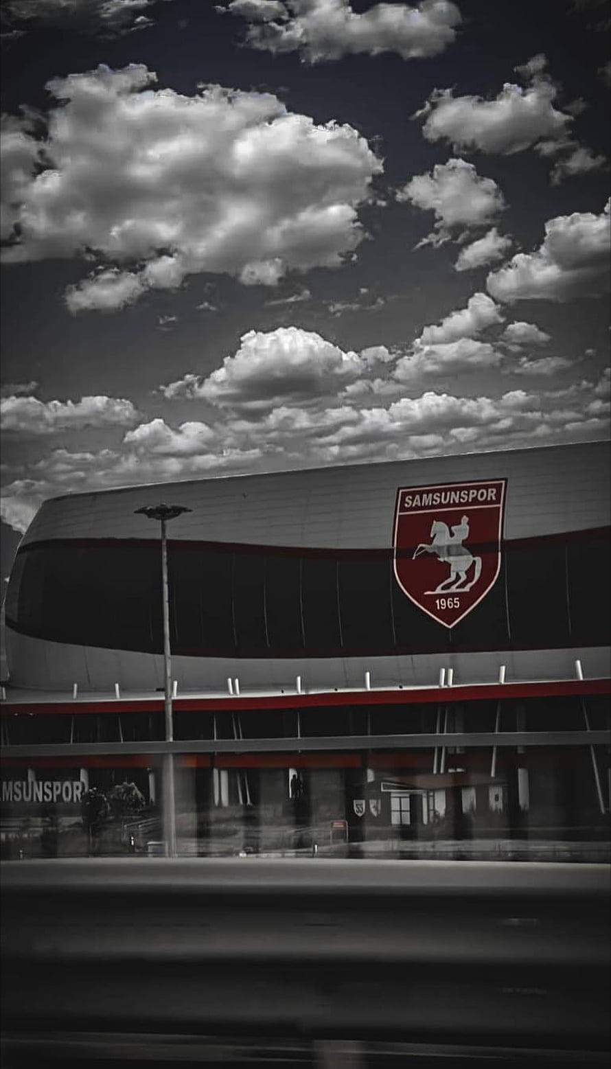 Samsunspor Stadium Exterior with Red Crest and Dramatic Cloudy Sky HD phone wallpaper