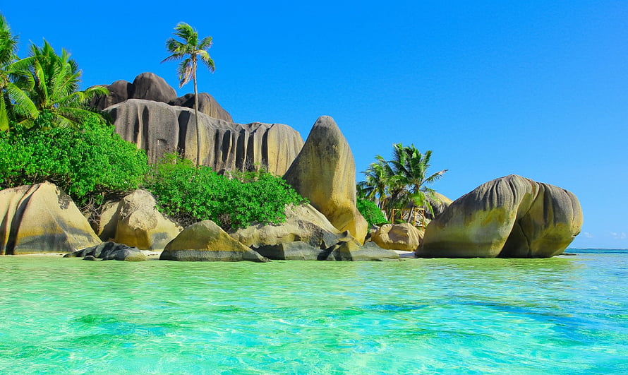 Tropical Island Beach With Granite Boulders, Palm Trees, And Turquoise Water HD wallpaper