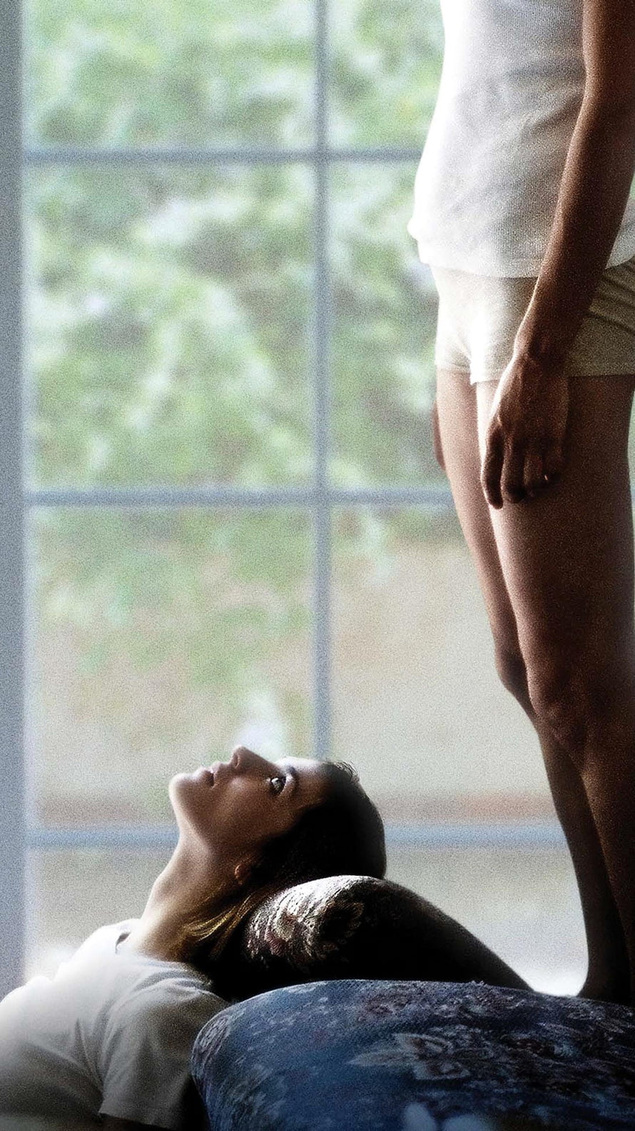 Dogtooth Movie Still: Woman Lying on Floor Gazing Up at Standing Figure by Window HD phone wallpaper