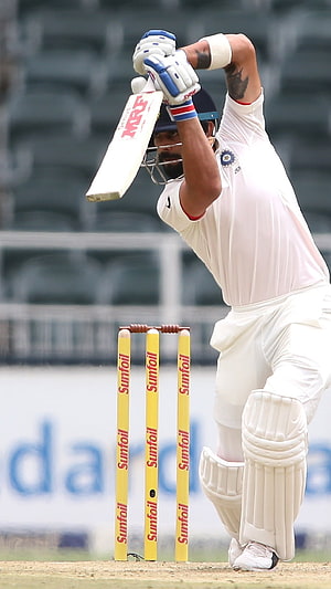 Virat Kohli in Action During a Test Match with MRF Bat and Sunfoil Stumps HD phone wallpaper