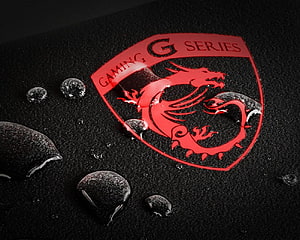 MSI Gaming G Series Dragon Logo on Black Textured Surface with Water Droplets HD wallpaper