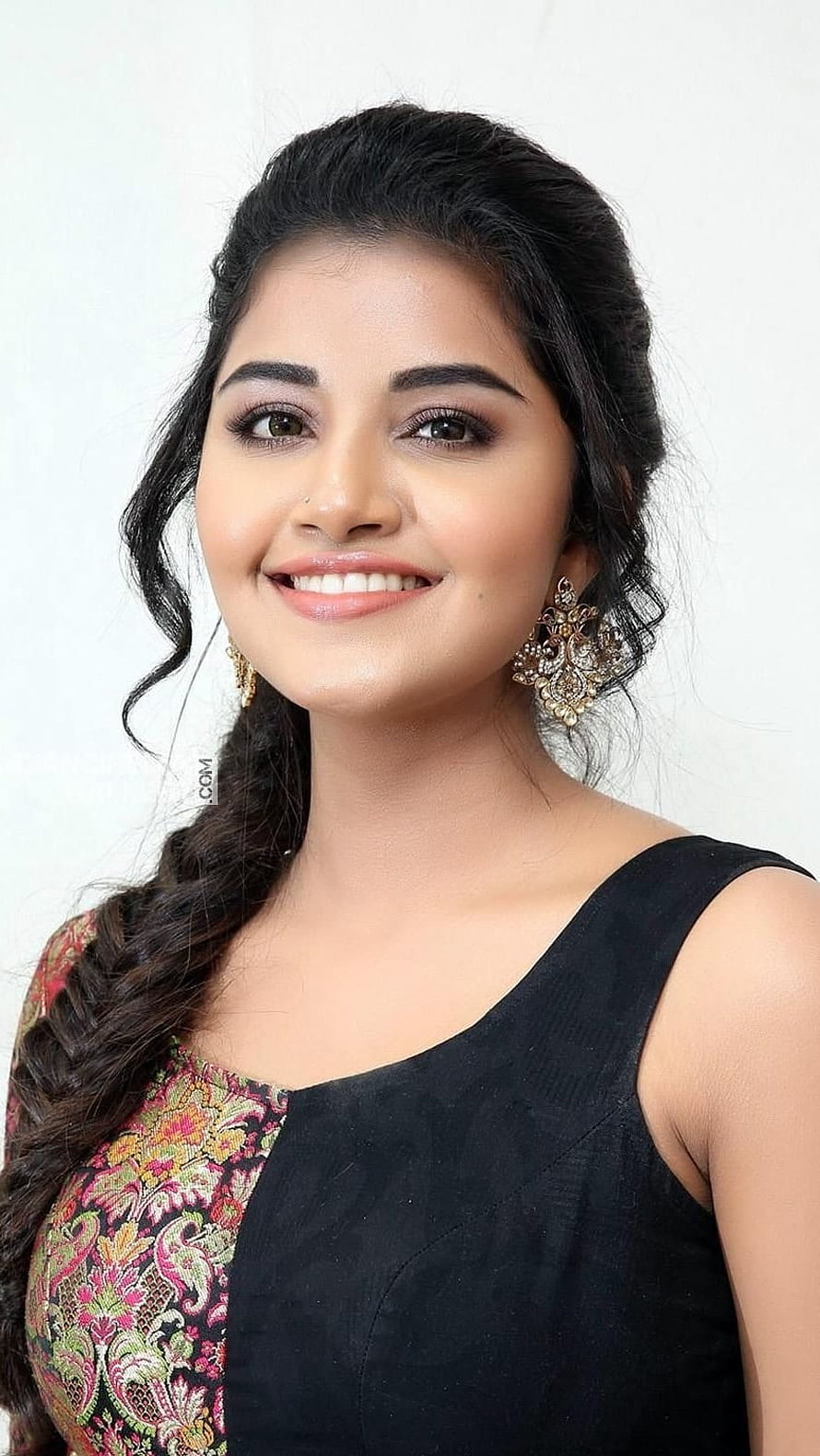 Anupama Parameswaran Portrait in Black and Floral Saree with Gold Earrings HD phone wallpaper
